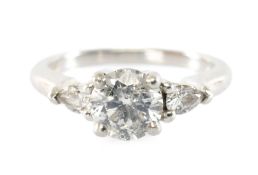 DIAMOND PLATINUM TRILOGY RING, the principal brilliant-cut stone set above pear-cut shoulders, on