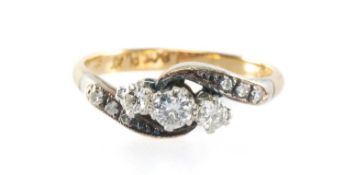 DIAMOND THREE-STONE CROSSOVER RING, set with three old round-cut diamonds totalling approx. 0.