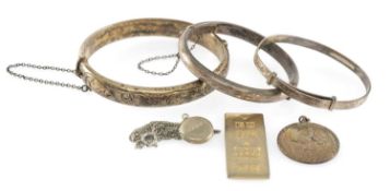 THREE SILVER BANGLES, the largest cuff size 60mms and the smallest 47mms, a silver St Christopher