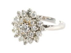 DIAMOND CLUSTER RING in 18ct white gold, set with 25 round brilliants, centred with a stone of