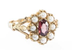 ATTRACTIVE GARNET & PEARL CLUSTER RING, centred with an oval-cut garnet, bordered with pearls, in