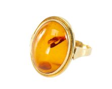 14K AMBER RING, oval cabochon with seed inclusions, ring size P, 4.2g Provenance: private collection
