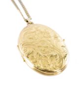 9CT GOLD FOLIATE ENGRAVED OVAL PICTURE LOCKET (modern), 50 x 33mms, suspended from a 9ct gold curb-