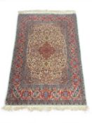 QUALITY KASHAN WOOLLEN RUG, signed, Iran, late 20th century, with a busy fawn field centred with a