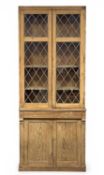 STRIPPED PINE GLAZED PARLOUR CABINET, the top with leaded glass doors opening to shelves, over
