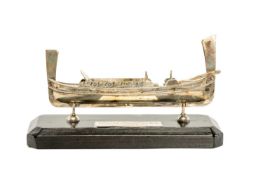 WHITE METAL BOAT, modelled as a gondola, stamped '925', on ebonised base with plaque engraved 'Malta