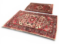 TWO RED GROUND PERSIAN RUGS, 115 x 74cms and 85 x 63cms (2) Provenance: private collection Cheshire