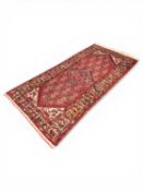PERSIAN HANDMADE WOOL RUG, red ground with floral border, 210 x 100cms Provenance: private