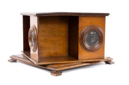 EDWARDIAN OAK REVOLVING TABLETOP BOOKSTAND, of square form, having four circular inset copper panels