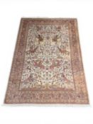 INDIAN PICTORIAL WOOLLEN RUG, the fawn field detailed with hunters on horseback, with numerous birds