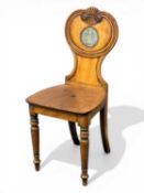 GEORGE IV MAHOGANY HALL CHAIR, carved back with an oval painted heraldic shield, lion with arrow,