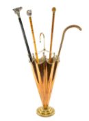 BRASS UMBRELLA-FORM STICK STAND, with four mixed walking canes Provenance: private collection