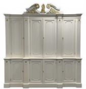 IMPRESSIVE CREAM PAINTED BREAKFRONT HANGING WARDROBE, Kent style, swan neck pediment, applied gilded
