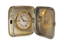 GEORGE V SILVER-CASED TRAVEL CLOCK, folding case with engine turned decoration, silvered dial with