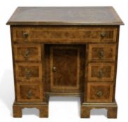 APPRENTICE PIECE WALNUT KNEEHOLE DESK, with quarter veneered top, cross banded throughout, on