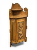 EDWARDIAN OAK FREESTANDING CORNER CUPBOARD, the raised back with centre shelf and scroll detail,