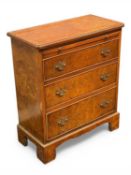 20TH CENTURY BURR WALNUT BACHELOR'S CHEST with brushing slide and three long drawers, brass drop