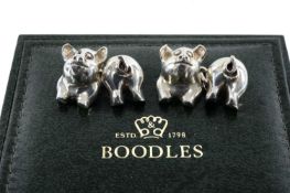 AMUSING PAIR OF STERLING SILVER CHAIN CUFFLINKS in the form of piglets, 24.4g, presented in Boodle &