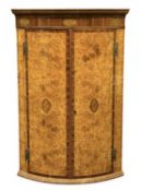 ‡ UNUSUAL POLLARD OAK & INLAID BOW-FRONT HANGING CORNER CUPBOARD, the doors with section veneers