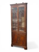 ARTHUR BRETT MAHOGANY FREE-STANDING CORNER CUPBOARD, moulded dentil cornice over astragal glazed