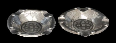 PAIR OF EASTERN WHITE METAL ASHTRAYS, circular and engraved with Celtic style knotwork design,