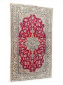 HAMADAN CRIMSON GROUND WOOLLEN RUG, mid to late 19th century, 203 x 120cms Provenance: private