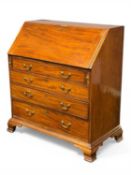 GEORGE III MAHOGANY BUREAU, fall front enclosing interior fitted with cubby holes, drawers, and