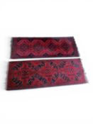 TWO AFGHAN MOHAMMADI RUNNERS, red and black ground, each 148 x 54cms (2) Provenance: private