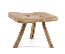 PRIMITIVE WINDTHROWN WOOD TRIPOD STOOL, the rectangular seat of distinctive grain, with three
