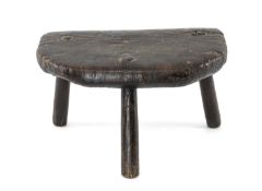 PRIMITIVE STOOL probably early 19th century, of D-Form solid slab seat with chamfered edge, tapering