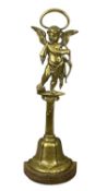 19TH CENTURY BRASS DOORSTOP, with loop handle, cherub standing on a pedestal to the bell-form