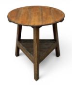 ANTIQUE OAK AND PINE CRICKET TABLE, with base shelf, 71 (h) x 69cms (diam.) Provenance: private