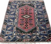 EASTERN WOOLLEN RUG, red and blue ground with multiple patterned borders and central diamond