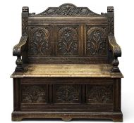 GOOD 19TH CENTURY OAK BOX SEAT SETTLE carved throughout, 111 (h) x 107 (w) x 49cms (d) Provenance: