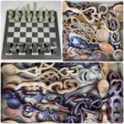 INIGO JONES & CO. SLATE CHESSBOARD & CHESSMEN, together with a collection of hand-carved wooden