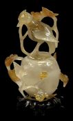 CHINESE CARVED CARNELIAN AGATE VASE & COVER, 20th century, with bird finial and on hardwood base,