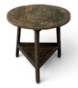 CARVED PINE CRICKET TABLE, with base shelf, 72 (h) x 70cms (diam.) Provenance: private collection