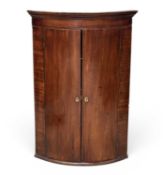 ANTIQUE MAHOGANY BOW-FRONT WALL-HANGING CORNER CUPBOARD, 106 (h) x 103 (w) x 50cms (d) Provenance: