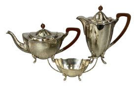 GEORGE VI SILVER THREE-PIECE TEA SERVICE, of shaped oval form, each piece standing on four paw feet,