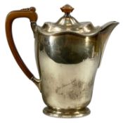 GEORGE VI SILVER HOT WATER POT, of plain oval form, wooden handle and finial, William Suckling Ltd.,