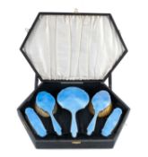 GEORGE V SILVER & BLUE GUILLOCHÉ ENAMEL FIVE-PIECE DRESSING TABLE SET, hand mirror and four brushes,