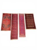 FOUR EASTERN HANDMADE WOOLLEN RUGS comprising a Belouch narrow runner, 290 x 68cms; further
