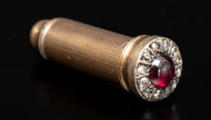 VICTORIAN YELLOW METAL PROPELLING PENCIL, terminal mounted with a cabochon ruby surrounded by rose-