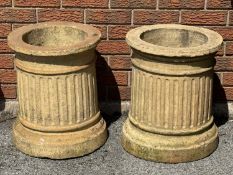 TWO CYLINDRICAL HOLLOW TERRACOTTA COLUMNS with fluted detail, 50 (h) x 43cms (diam.) Provenance: