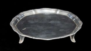 GEORGE V SILVER CARD TRAY having a moulded gadrooned border, on four feet, Thomas Bradbury & Sons,