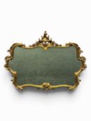 ORNATE ROCOCO STYLE GILT FRAMED WALL MIRROR being pierced and carved with scrolls, 102 (h) x 134 (w)