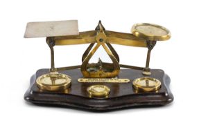 BRASS LETTER SCALES & WEIGHTS, on shaped mahogany base, 21cms (w) Provenance: private collection