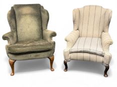 TWO VINTAGE WING-BACK ARMCHAIRS in green dralon upholstered with outswept arms and carved cabriole