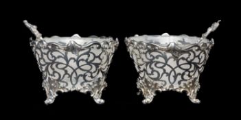 FINE PAIR OF VICTORIAN CAST SILVER SALTS of circular form, pierced sides, opaque glass liners,