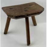 WELSH ASH & ELM MILKING STOOL having a rectangular slab seat with canted corners and chamfered